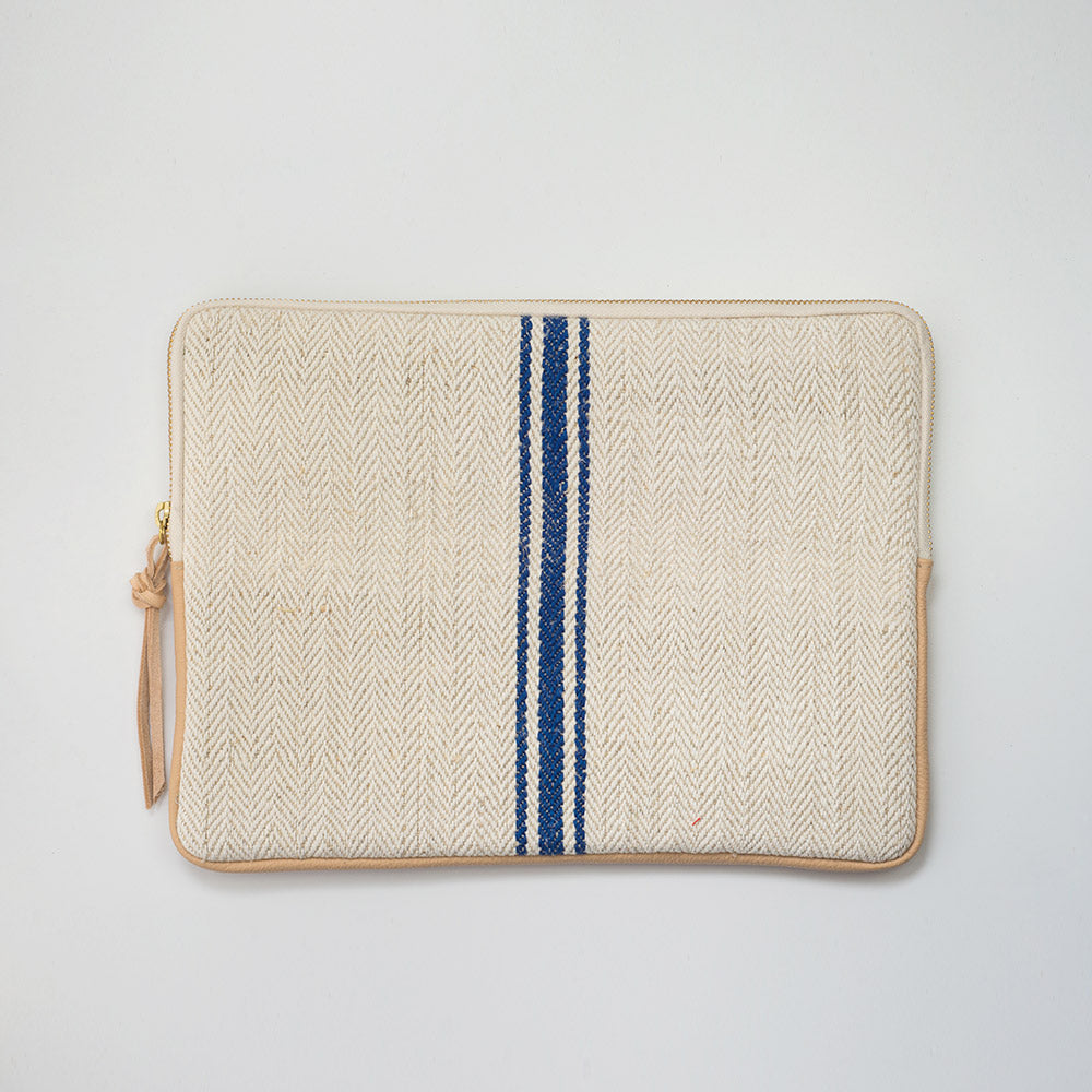 MacBook cover handcrafted from a 100 years old grain sack and Spanish leather .