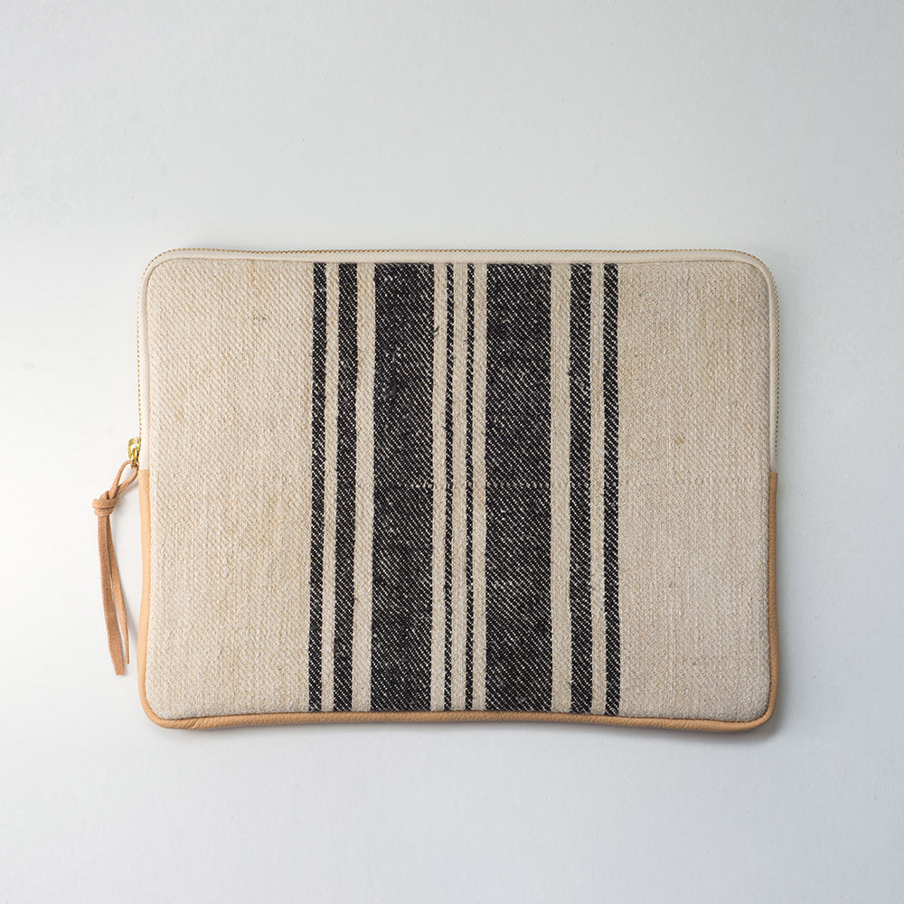 MacBook cover handcrafted  from a 100 years old grain sack and Spanish leather .