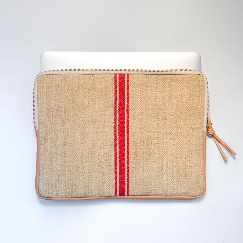 MacBook cover handcrafted  from a 100 years old grain sack and Spanish leather .